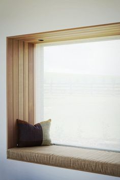 a wooden window sill with a pillow on it