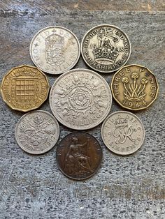 six different british coins sitting on top of each other