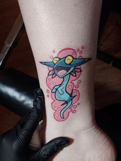 a person with a tattoo on their foot that has an image of a cartoon character