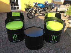 three black and green chairs sitting on top of a brick floor next to a motorcycle