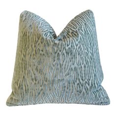 a blue and gold pillow with an animal print pattern on the front, sitting on a white background