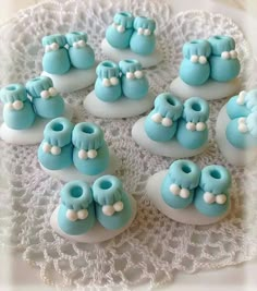 small blue baby booties are on a doily