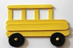 a yellow wooden toy truck with black wheels on a white surface, ready to be made into a wall decoration