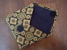 two pieces of fabric sitting next to each other on a wooden floor with a black square in the middle