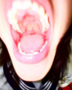 a close up of a person's mouth and tongue