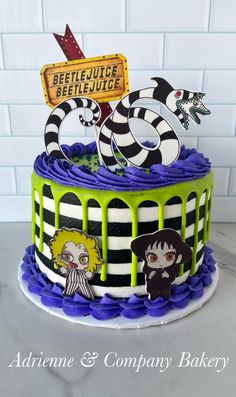 a cake decorated with an image of beetlejuice, beetle - man and other characters