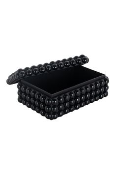 two black trays with beads on the bottom and one in the middle, sitting side by side