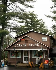 the corner store is located in front of some trees and has many items on display