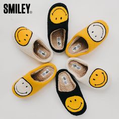 four pairs of shoes with smiley faces painted on the soles and one pair has been made to look like slippers