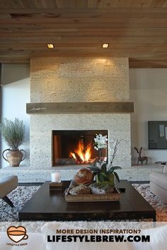 a living room filled with furniture and a fire place next to a wall mounted tv