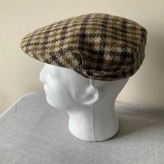 Traditional country gentleman's woollen cloth cap with snap-closed down peak and brown fabric lining. Dunn & Co, Great Britain. Will fit a very small head, Small man or boy. Size 55 cm, 6 3/4. Nice tweed fabric , beige , black and olive checked wool. Good vintage condition. For more vintage accessories and clothes, visit my shop https://www.etsy.com/uk/shop/coolclobber Fitted Wool Flat Cap, Classic Brown Beret With Curved Brim, Winter Wool Baseball Cap With Short Brim, Classic Wool Baseball Cap For Winter, Classic Brown Beret With Short Brim, Retro Brown Flat Cap Baseball Cap, Classic Wool Beret With Short Brim, Classic Brown Flat Cap Baseball Cap, Classic Felt Cap For Winter