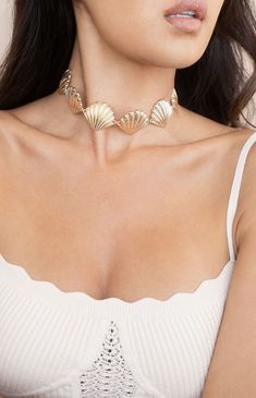 Online only! Turn heads with Ettika's Scallop Shell Body Chain, featuring a striking seashell design that drapes elegantly across the body. The gold finish adds a touch of luxury, making it a standout accessory for any occasion.


	Gold Tone, Zinc
	31" with 7" extender
	Lobster Clasp Elegant Metal Jewelry For Beach, Ocean-inspired Metal Jewelry, Elegant Gold Shell-shaped Jewelry, Shell-shaped Clavicle Chain Necklace, Elegant Shell-shaped Necklace With Clavicle Chain, Elegant Shell-shaped Metal Jewelry, Elegant Shell-shaped Summer Jewelry, Gold Summer Choker, Elegant Summer Shell-shaped Jewelry