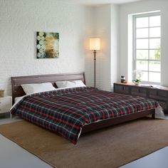 a bedroom with a bed, nightstands and two lamps on either side of the window