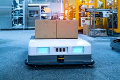 two boxes on top of a cart in a warehouse