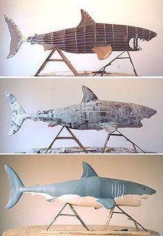 three different types of shark sculptures sitting on top of a wooden table next to each other