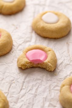 some cookies with pink icing on top of them