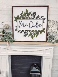 a fireplace mantel with a sign above it that says mcc cake on the mantle