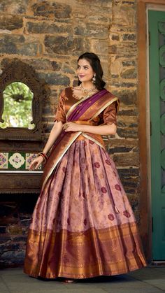 Made from purple color jacquard silk zari weaving work which is a rich, intricately woven fabric with complex patterns that are often raised and textured. 
 This ensemble is perfect for making a grand statement at any special occasion, combining timeless tradition with contemporary elegance. Brown Half Saree, Kanchi Pattu Lehenga Half Saree, Pattu Lehenga Half Saree, Lehenga Half Saree, Purple Color Combinations, Lehenga Crop Top, Half Saree Lehenga, Gown Party Wear