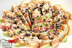 sliced apples with chocolate chips and sprinkles arranged in a circle on a white plate