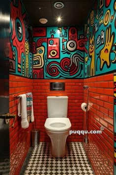 a toilet in a brightly colored bathroom with black and white checkered flooring on the walls