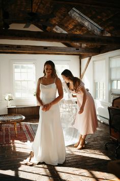 two women in wedding dresses standing near each other