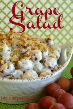 grape salad in a white bowl with grapes around it and the words grape salad on top