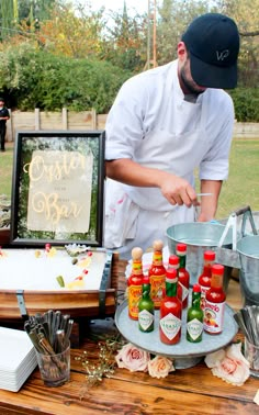 a chef is preparing condiments on a table