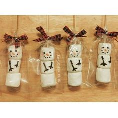 four snowman marshmallows wrapped in cellophane