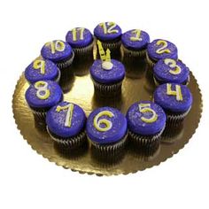 a cake with blue cupcakes and numbers on the top that says happy birthday