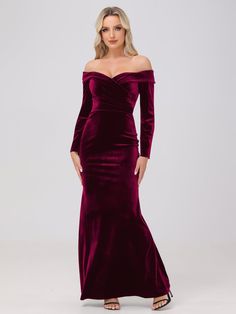 a woman wearing a long velvet dress with off the shoulder sleeves and thigh slits