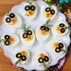 deviled eggs with olives and anchovies are arranged on a platter