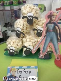 a table topped with lots of popcorn covered in sheep