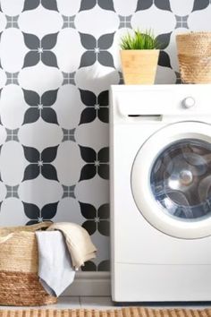 a white washer sitting next to a dryer in a room