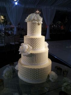 a wedding cake with white flowers on top