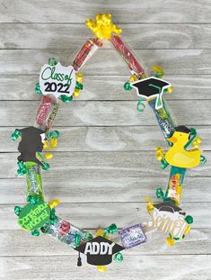 a wreath made out of candy and graduation decorations