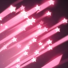 pink and white stars are flying in the air