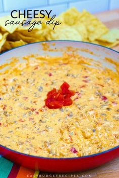 cheesy salsa dip in a red bowl with chips on the side