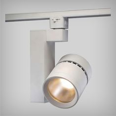 a white track light mounted on the side of a wall with a dimmer in front of it