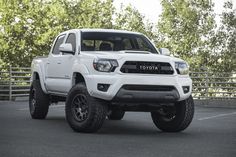 a white toyota truck parked in a parking lot