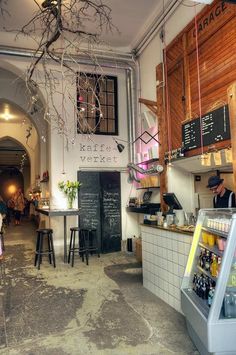 the inside of a restaurant with tables and stools