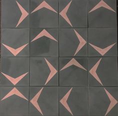 the tiles have pink and grey shapes on them