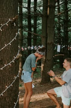 two people in the woods talking to each other