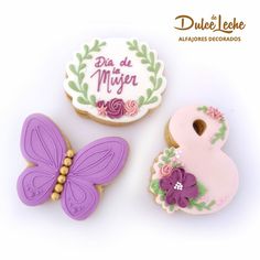 three decorated cookies with the words dia de muer and a butterfly on one cookie