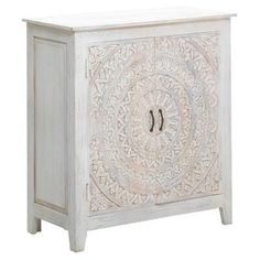 a white cabinet with an intricate design on the front and side doors, it has two drawers