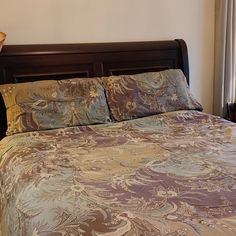 a bedroom with a large bed and wooden headboard