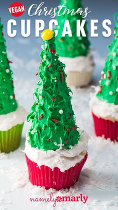 vegan christmas cupcakes with green frosting and trees on top, surrounded by snow