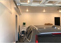 a car is parked in the garage with its door open