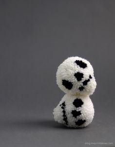 a white and black stuffed animal sitting on top of a table