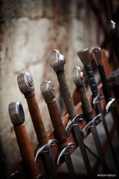 there are many different types of knives lined up on the rack in front of each other