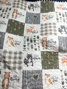 a baby quilt with animals and words on it